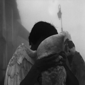 A person with wings hugging another person