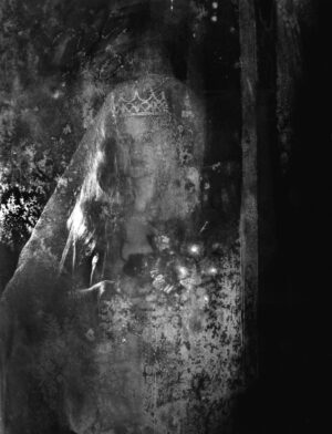 A black and white photo of a person in a veil.