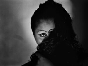 A woman with her face covered by the hair.