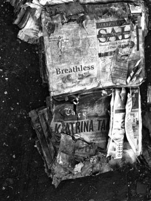 A bunch of newspapers are all on the ground