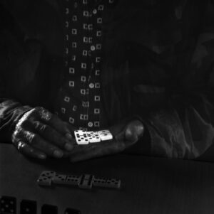 A man holding a dice in his hand.