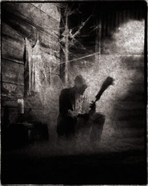 A man holding a guitar in the middle of an alley.