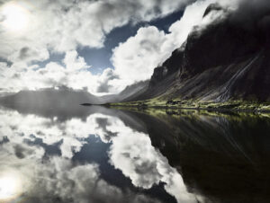 A body of water with mountains in the background