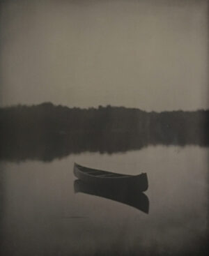A boat floating on top of a lake.