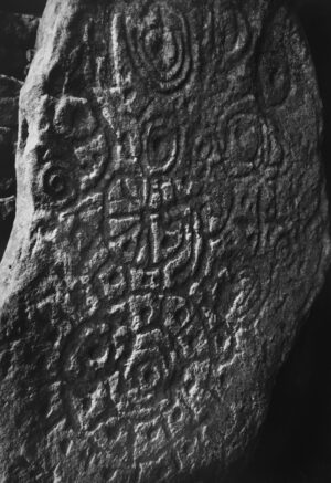 A stone with writing on it is shown.