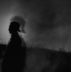 A person standing in the middle of a field.