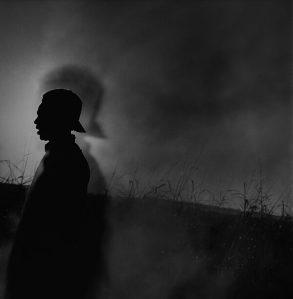 A person standing in the middle of a field.