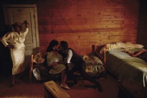 A couple is sitting on the couch in their living room.