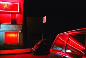 A car parked in the dark with red lights.