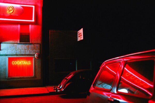 A car parked in the dark with red lights.