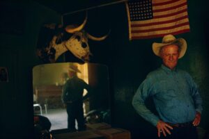 A man in a cowboy hat and a bull head.
