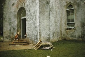A chair and some trash in front of a building.