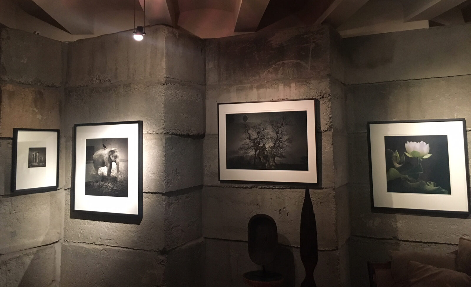 A room with three pictures hanging on the wall.