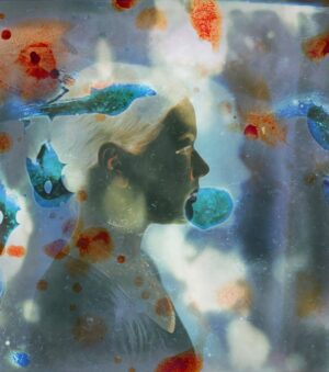 A woman is looking at the sky through a glass.