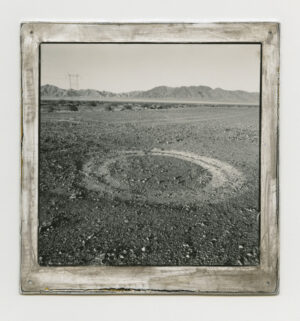 A black and white photo of an old field.