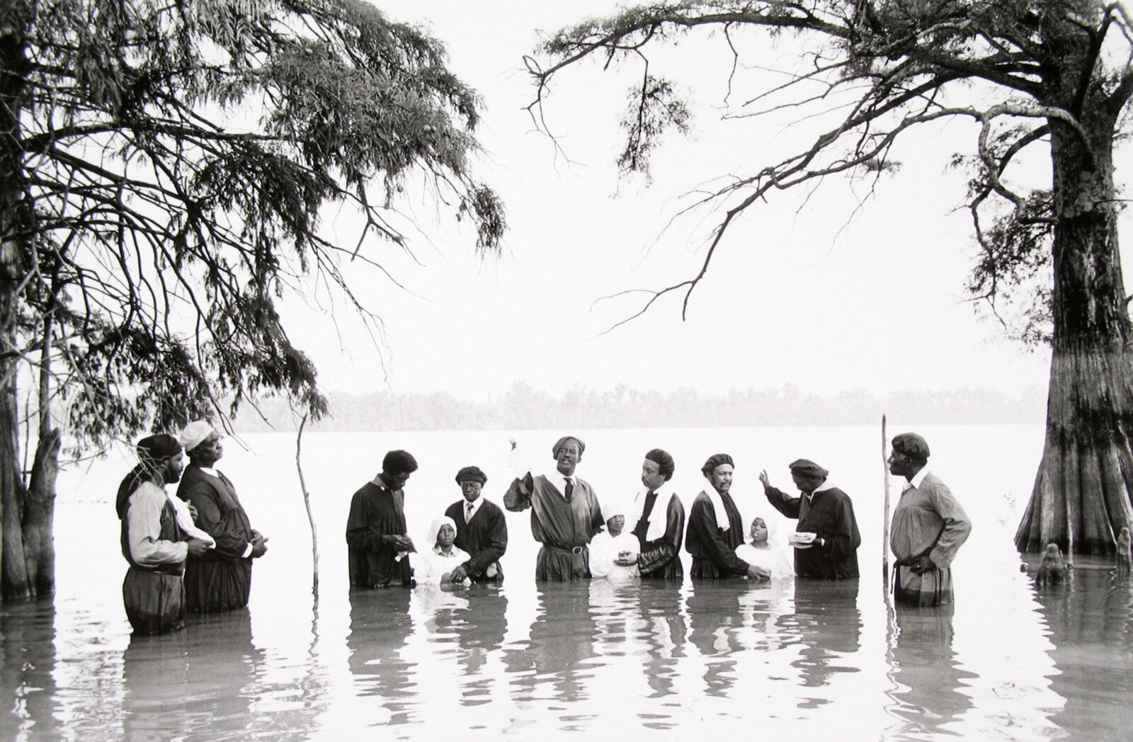 Group standing in water during ceremony.