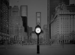 A clock in the middle of a city.