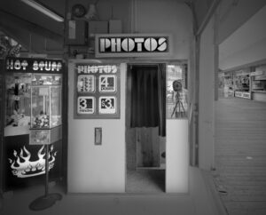 A photo booth in an old building with the words " photos ".