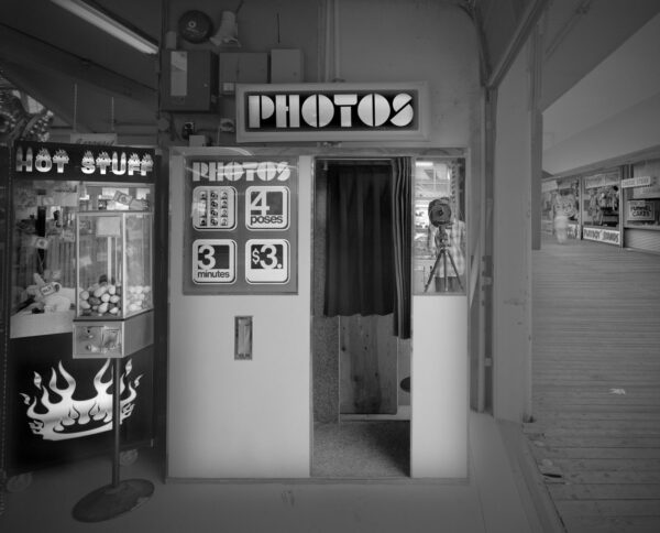 A photo booth in an old building with the words " photos ".