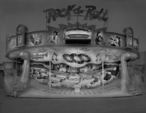 A black and white photo of an old fashioned ride.
