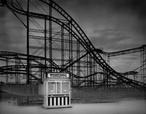 A black and white photo of a roller coaster.