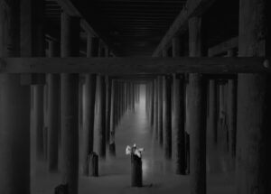 A person standing in the middle of an empty room.