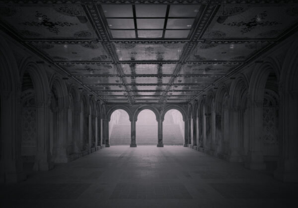 A large empty room with arches and pillars.