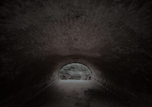 A dark tunnel with a light at the end of it.