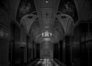 A black and white photo of an empty hallway.