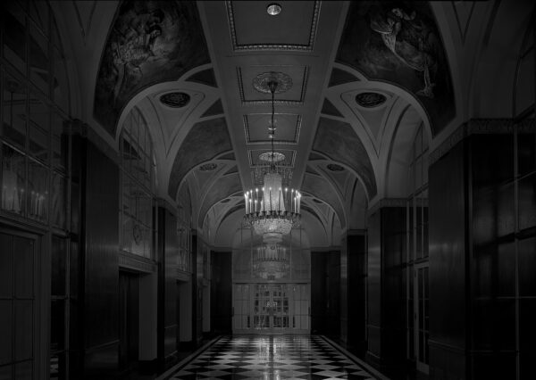 A black and white photo of an empty hallway.