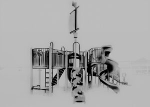 A black and white photo of a playground.