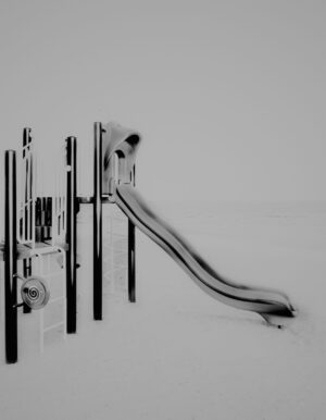 A black and white photo of a slide in the snow.