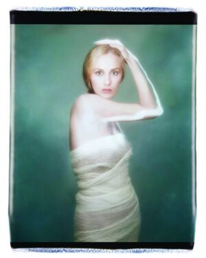 A woman in white dress posing for the camera.