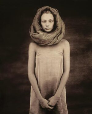 A woman with a scarf around her neck.