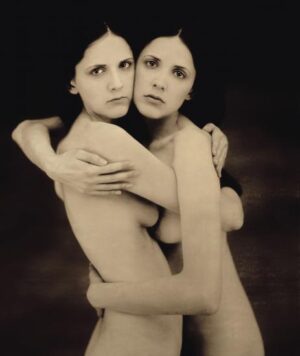 Two women embracing each other in a black and white photo.