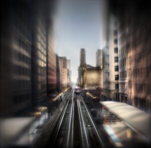 A blurry photo of the city with trains on it.