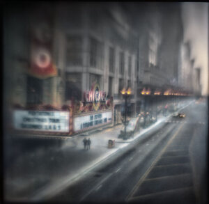 A blurry photo of the street corner in front of a building.