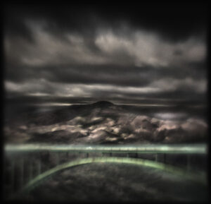 A dark sky with some clouds and rain