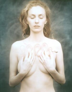 A woman with her hands on her chest.