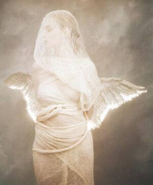 A statue of an angel with wings and a halo.