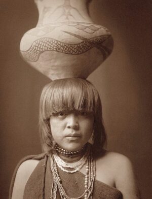 A woman with a basket on her head.