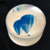 A blue blob is painted on the inside of a glass.