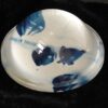A bowl with blue and white paint on it.