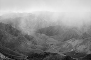 A black and white photo of mountains in the distance.