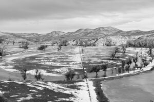 A black and white photo of an open field