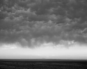 A black and white photo of the sky with clouds