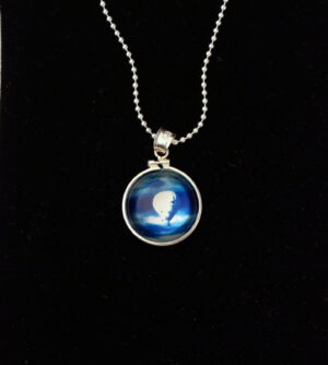 A necklace with a picture of the moon in it.