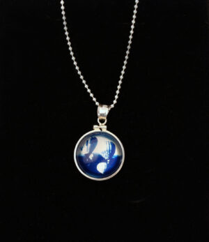 A necklace with a picture of the earth in it.