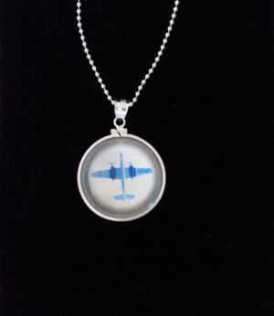 A necklace with a picture of an airplane in it.