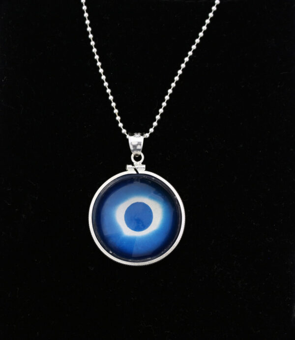 A necklace with an image of the sun in it.